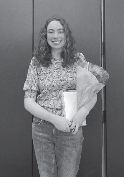 Hannah Brodsky ’25 holds the gifts she received after being named Poet Laureate on May 17.