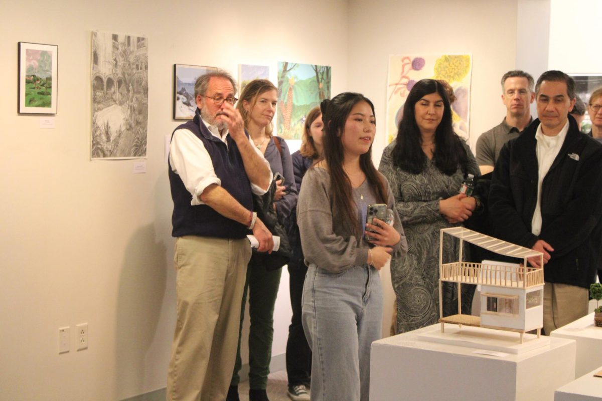 Saho Reppucci ’25 showcases an architecture piece to event attendees. (Staff Photo by Hailey Jiang)