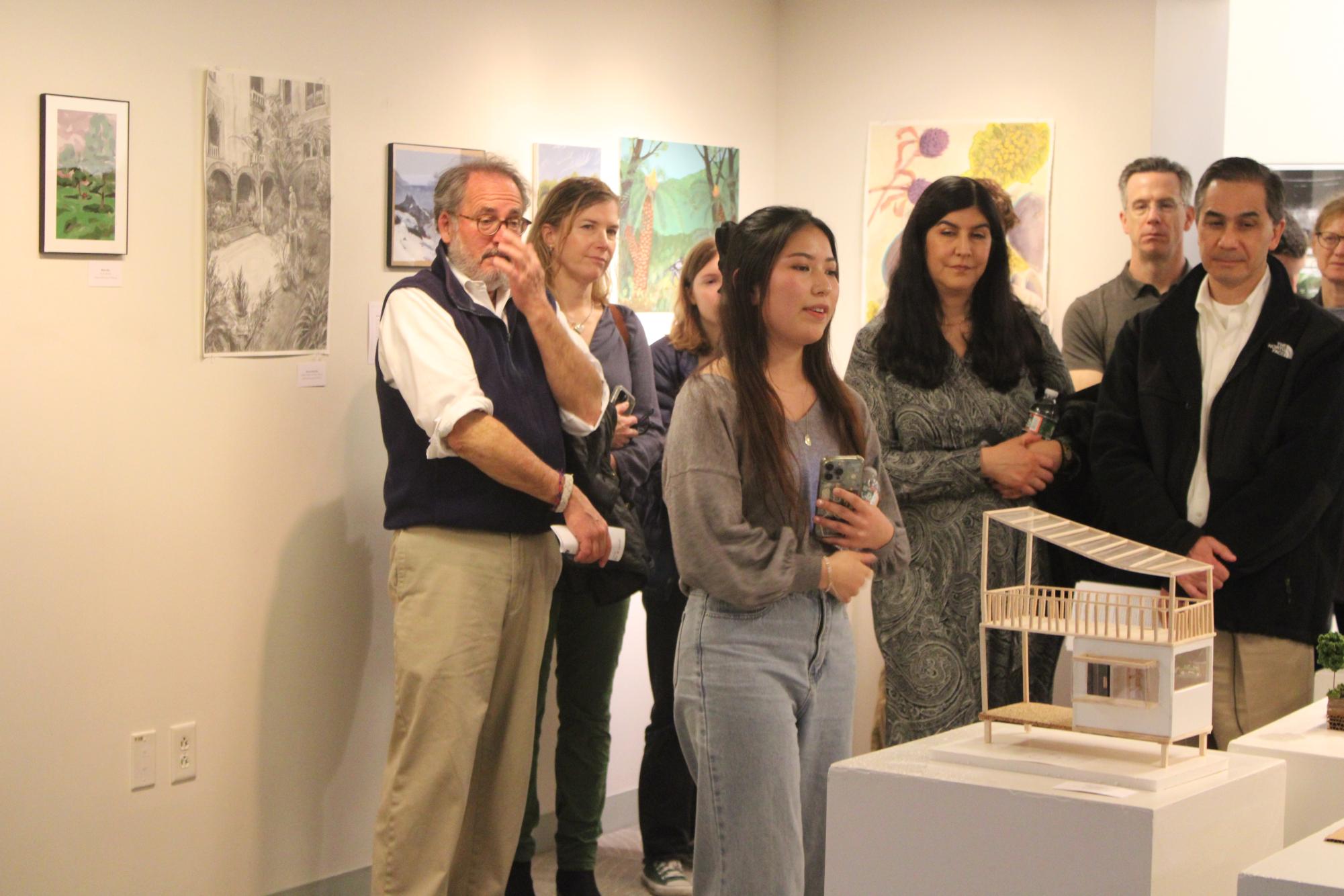 Saho Reppucci ’25 showcases an architecture piece to event attendees. (Staff Photo by Hailey Jiang)