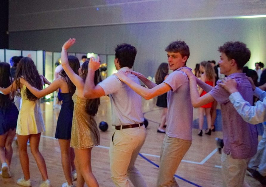 Ciel McGivern, Marina Kluzak, Kate Sullivan, Jack Williams, Jack Reinfeld and Will Sammons (all ’27) move in a conga line at the sophomore dance. (Photo Courtesy of Niyam Badani)