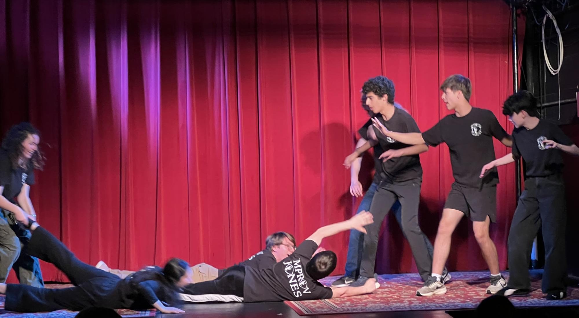 Salar Sekhavat ’26, Justin Hildebrandt and Gordon Miller (both ’27) attempt to ward off Evelyn Marks’ ’29 deadly bad breath performing with Improv Jones at the Regent Theater. (Staff Photo by Yancheng Zhao)