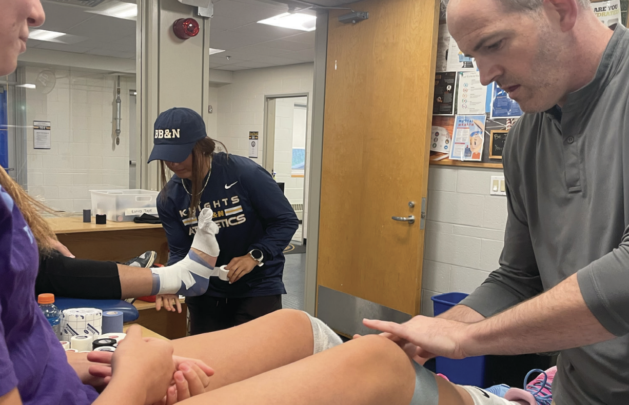 Adyson Balter ’29 gets her knee wrapped before practice. (Staff Photo by Katy Varadi)