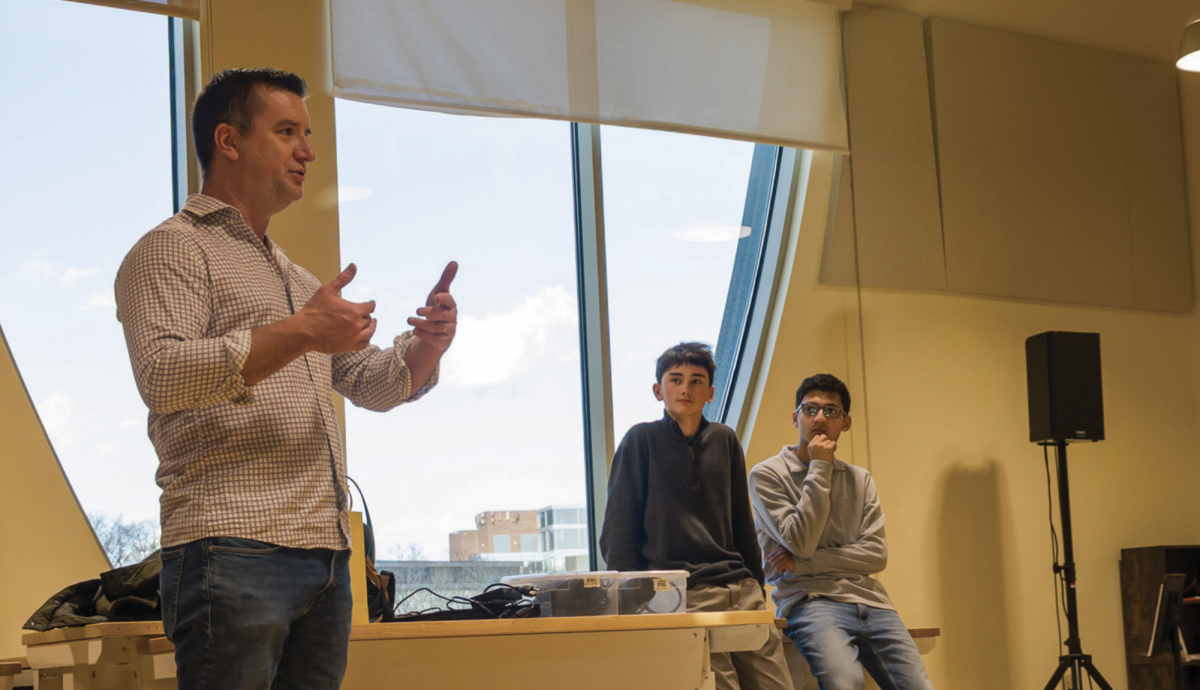 Dean Riaz and Charlie Zarrow (both ’28) invited commentator Christian Arcand ’00 to speak with their club on Jan. 15. (Staff Photo by Tristan Ko)