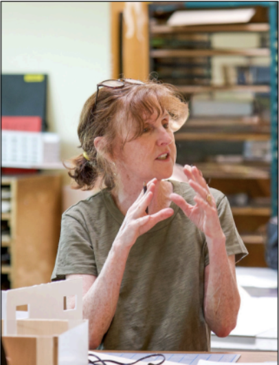 Ms. Tangusso helps students understand artistic concepts in the architecture studio.