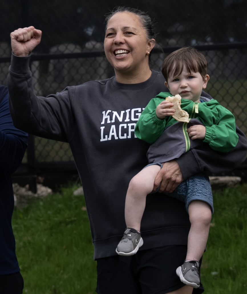 Coach Dorsey cheers on the Girls’ Varsity Lacrosse Team from the sidelines.