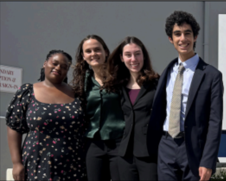Ms. Hudson celebrates her students Chloe Taft, Sophia Stafford (both
‘25) and Salar Sekhavat ‘26 after a debate tournament.
