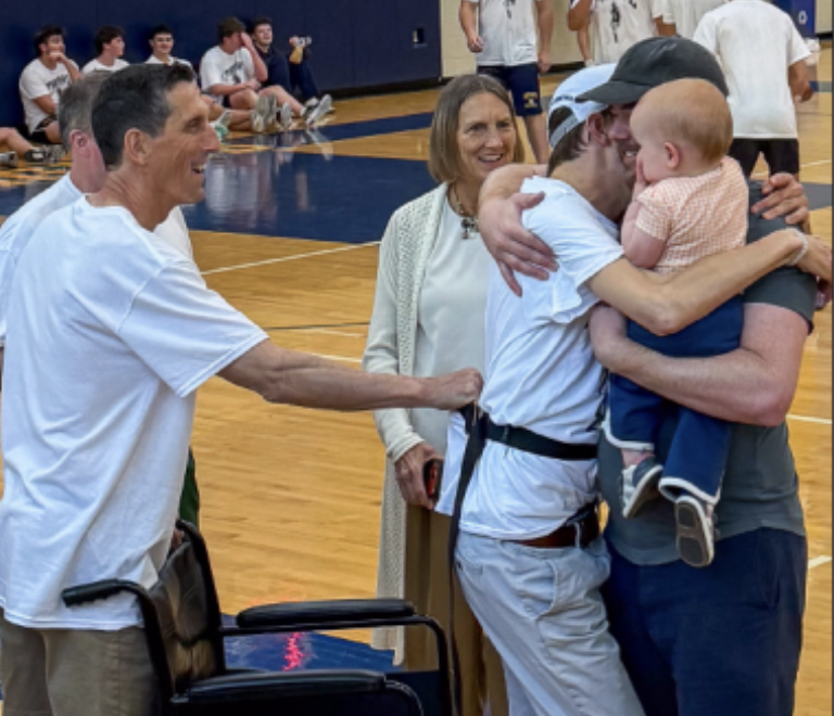 Zach McLeod ’10 embraces his family at the annual tournament in his name.